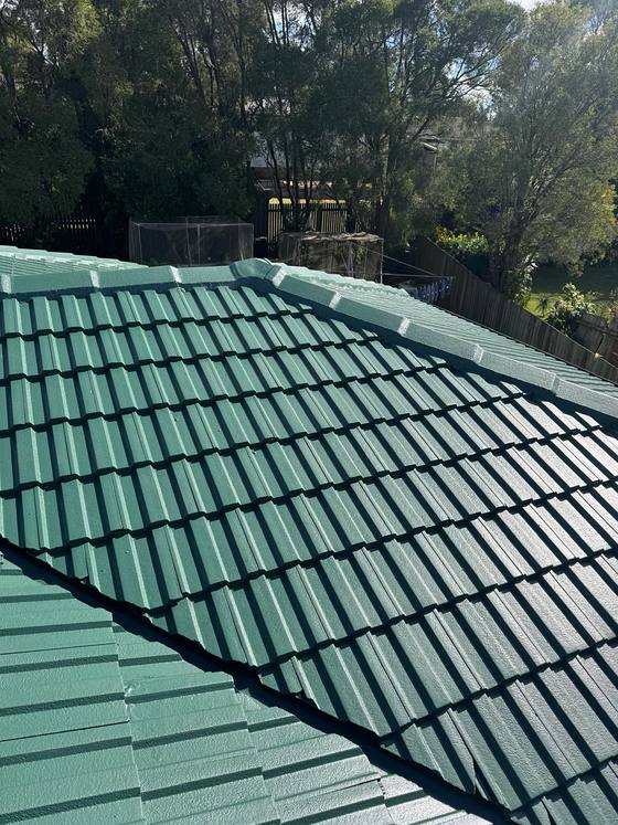 A tile roof finished in a deep green
